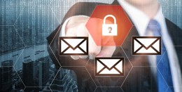 Businessman pressing e-mail security button on virtual screens for internet and e-mail security. Business, technology, internet and virtual reality concept