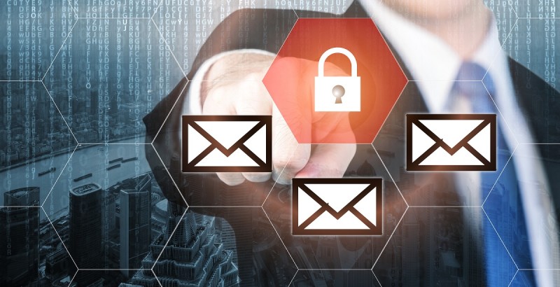 Businessman pressing e-mail security button on virtual screens for internet and e-mail security. Business, technology, internet and virtual reality concept