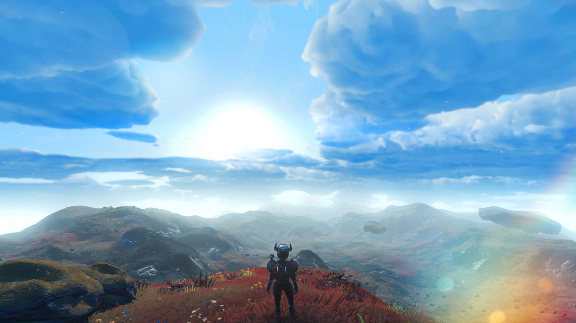 Un voyageur contemple un vaste paysage extraterrestre sous un ciel bleu