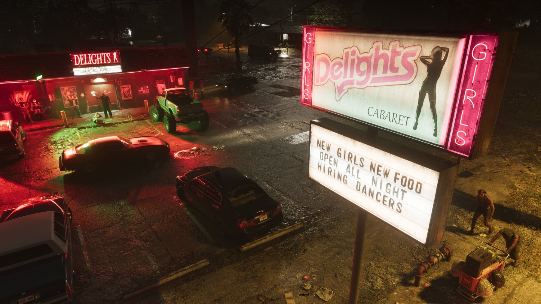 Des voitures circulent de nuit devant un commerce éclairé de Port Gellhorn dans GTA VI.