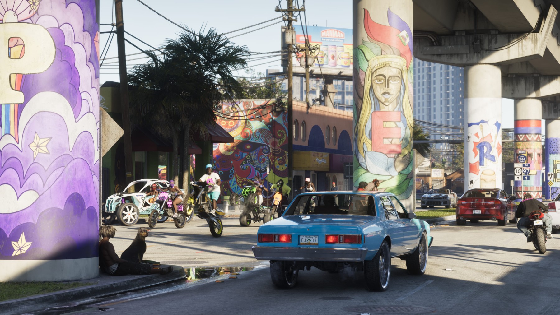 Une voiture traverse un quartier de Vice City décoré de murales colorées dans GTA VI.
