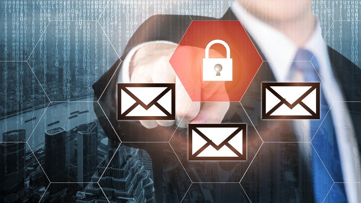 Businessman pressing e-mail security button on virtual screens for internet and e-mail security. Business, technology, internet and virtual reality concept